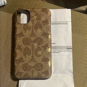 Coach Brown Cell Phone Case with Patterned Design and Textured Material